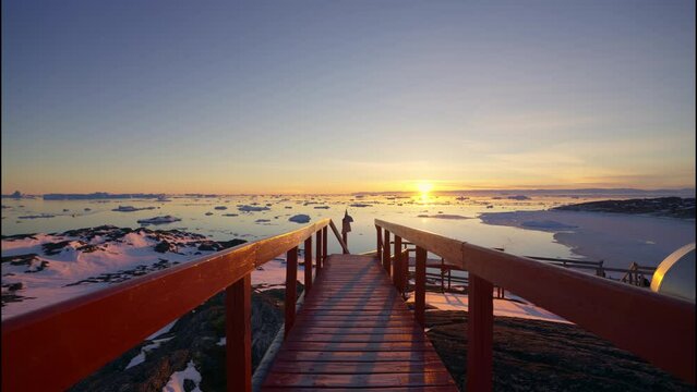 View Over Walkway Towards Sunset Over Sea Of Ilulissat Icefjord