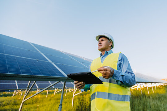 Engineer man working at alternative energy farm. Alternative eco energy concept