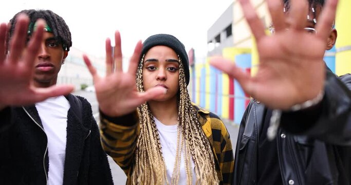 Multi ethic showing stop with hand gesture