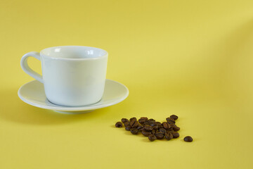 Tea pair on yellow background with coffee beans.