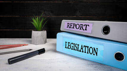 Legislation and Report. Document folders, binders and office supplies on a wooden background