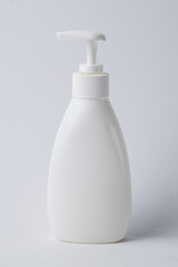 Liquid soap in a plastic bottle with a dispenser on a white background. The concept of skin care