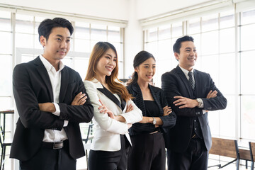 Portrait of business Asian people standing with arms cross during meeting in the office. Group of diverse businesspeople shared business strategy plan success.