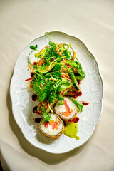 Spicy maguro salad with mix of greens, tuna, cucumber, avocado, cherry tomato, soy sprouts, kimchi sauce, narsharab sauce, lemon, microgreen isolated on black
