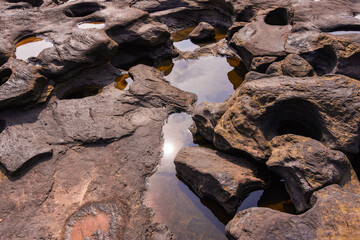 The stone slabs in the dry creek are broken. It is a slit hole because of the long erosion force of...
