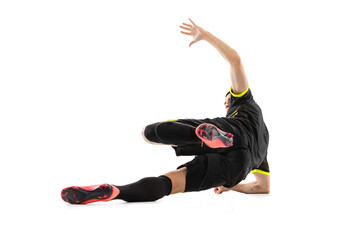 One professional male football soccer player doing sliding tackle isolated on white studio...