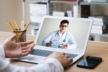 Concepts of online medicine, communicating with patients through online networks, technology and healthcare. Make a video call with a doctor on your laptop.