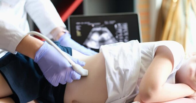 Medical examination of kidneys of little girl using ultrasound equipment