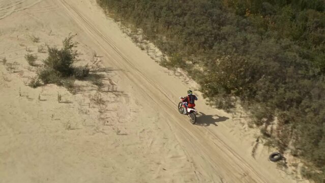 Enduro motorcycle rides off-road on the sands
