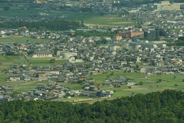 Ohmi Railway running on the Koto Plain in wheat harvest season