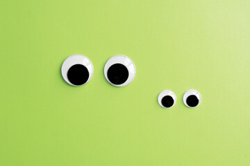 invisible frog googly eyes on green color background - obrazy, fototapety, plakaty