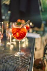 Wine glasses of fresh aperol spritz cocktails on the served table in a street summer cafe.