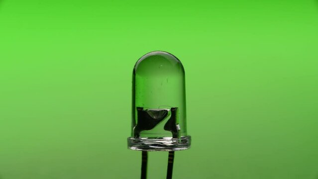 Close-up of Light-emitting diode (LED) blinking with green background
