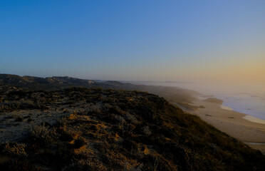 Fototapeta na wymiar twilight time by the ocean bay, hill at the ocean