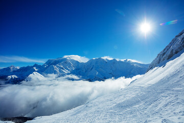 Valley in French Alps Mont Blanc mountains over clouds bellow