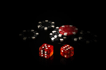 Dice and chips obtained from winnings while playing Craps. The idea of the game on a black background with space for advertising