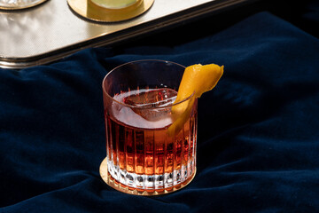 Negroni cocktail, italian recipe with gin, bitter and vermouth; garnished with orange peel, in...