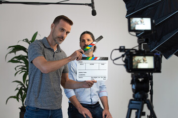 Behind the Scenes on a Video Production Set. Director Uses Clapper Slate to Signify Action. Video...