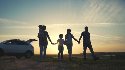 people in the park. happy family a silhouette walk at sunset. car travel kid dream concept. happy...