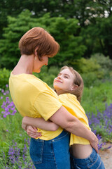 Fototapeta premium active mother and daughter walking along the path in the summer park