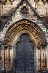 The ancient door of the cathedral. English architecture