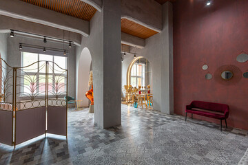 interior of a large apartment in oriental mixed with loft style with arches, led lighting and bright orange elements