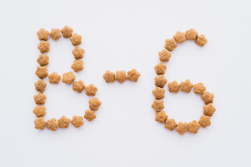 flat lay of word made of dry pet food isolated on white.