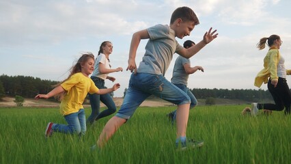 happy family run. children kid a together run in the park at sunset. people in the park concept. mom dad daughter and son joyful run energy. happy family and little baby child kid dream concept fun