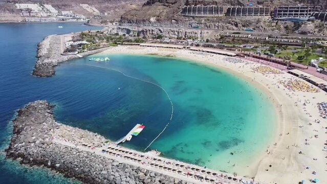 Aerial drone footage. Playa de Amadores, large cove with a white sand beach. Puerto Rico de Gran Canaria, Canary Islands, Spain.	