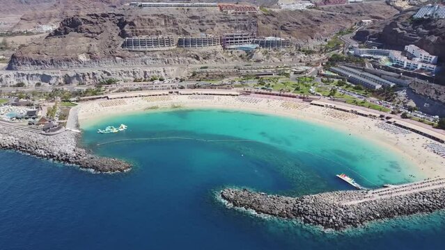 Aerial drone footage. Playa de Amadores, large cove with a white sand beach. Puerto Rico de Gran Canaria, Canary Islands, Spain.	