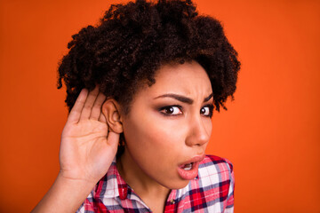 Photo of funky impressed woman wear plaid shirt arm ear listening you isolated orange color...