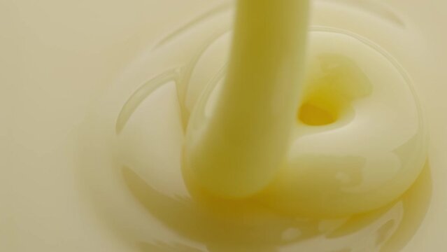 Pouring cream. Close-up shot.