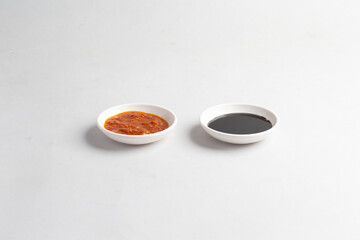 asian chicken rice spicy chilli sauce with thick dark sweet black soya sauce in white background halal sauce