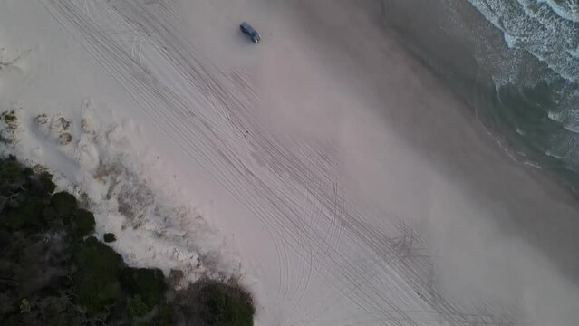 Car driving on Bribie Island beach in Queensland, Australia