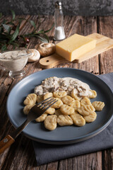 Cooked traditional Italian gnocchi dish with creamy mushroom sauce and cheese
