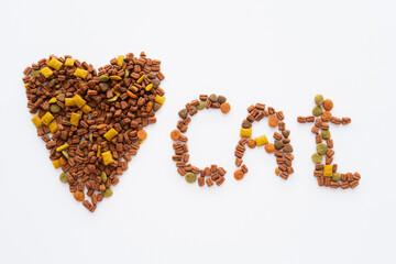 top view of heart and cat lettering made of dry pet food isolated on white.
