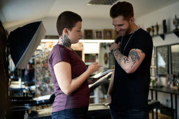 Two caucasian people with tattoo discussion about new project