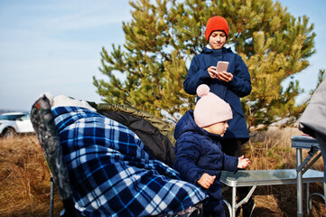 Fototapeta na wymiar Kids in picnic at the pine forest.