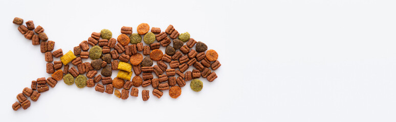 shape of fish made with dry pet food isolated on white, banner.