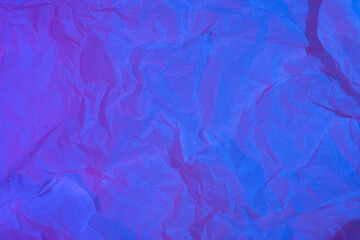 Abstract crumpled paper background in neon light
