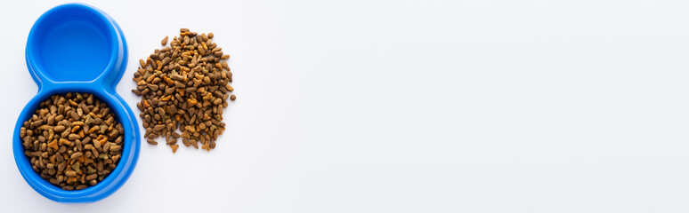 top view of refreshing water in bowl near dry pet food isolated on white, banner.