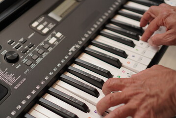 Man's hands playing keyboard