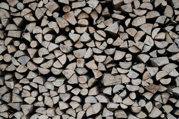 Gray and brown chopped stacked firewood background Natural eco texture