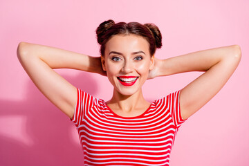 Portrait of adorable peaceful lady arms behind head toothy smile enjoy free time isolated on pink color background
