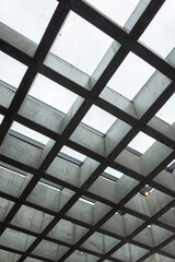 Modern interior, grid ceiling, cloudy sky