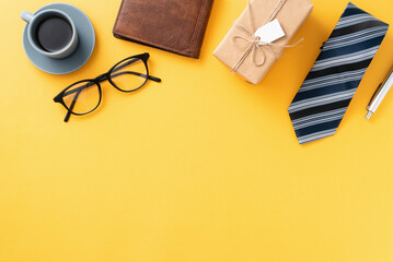 Father's day gift design concept with gift box and necktie on yellow background.