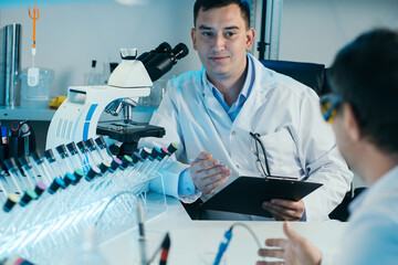 Scientist working with microscope in lab. Laboratory research concept.