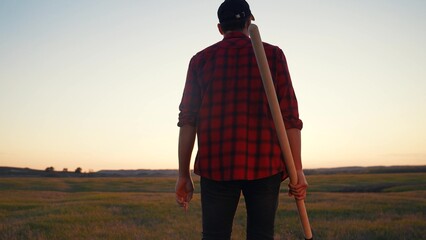 agriculture. farmer with a shovel walk in the field. agriculture business sun harvesting of a...