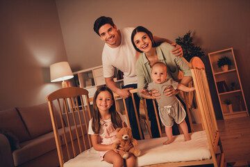 Photo of cheerful sweet mother father little children having fun late night indoors room home house