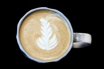 A cup of coffee latte art, isolated on black background